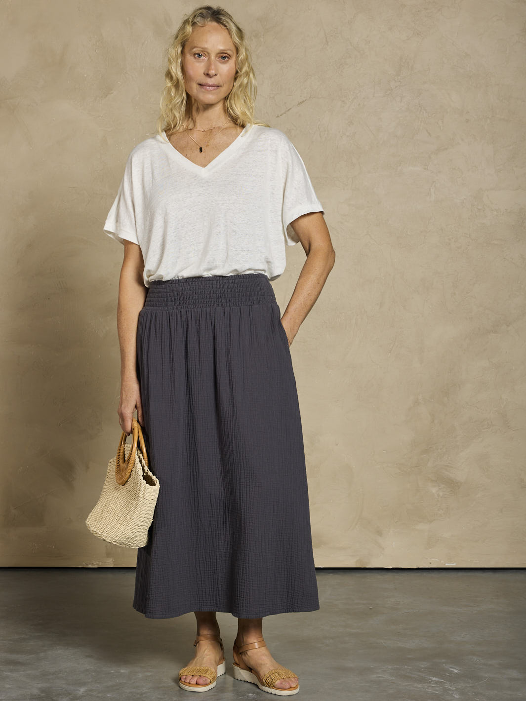 Woman in a white linen top and black cotton skirt