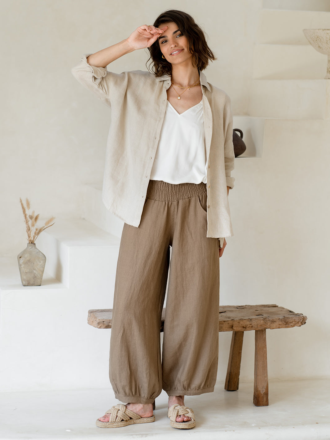 Model wears Sadhu French Linen Pants Regular in Cinnamon.