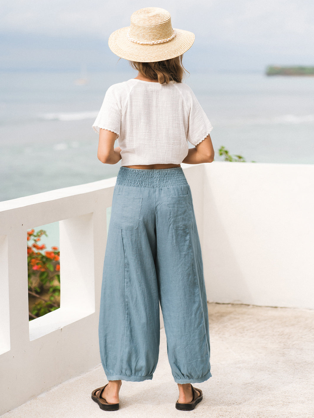 Model wears Sadhu French Linen Pants Regular in Tahiti Blue.