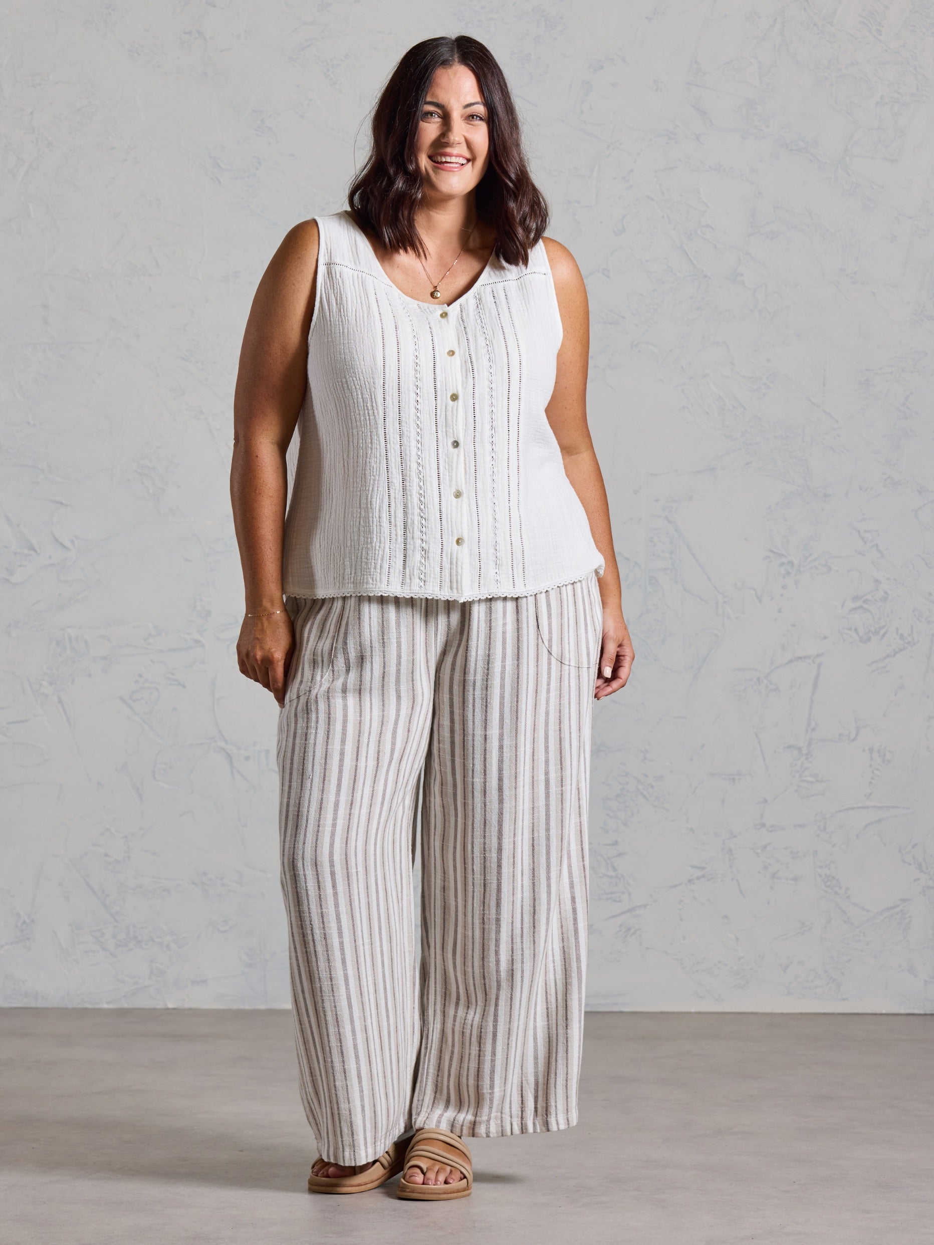 Curve model in the Ceres Organic Cotton Top in coconut, styled with wide leg striped linen pants.