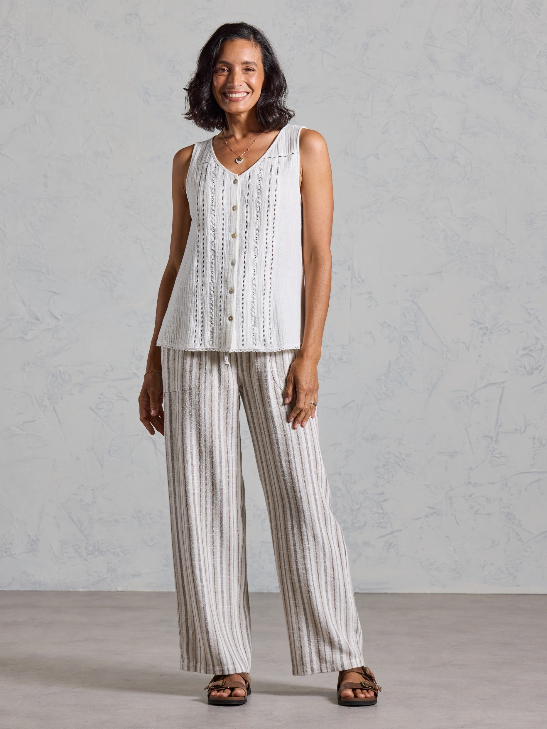Full length view of the Ceres Organic Cotton Top in coconut, paired with striped wide leg linen pants.