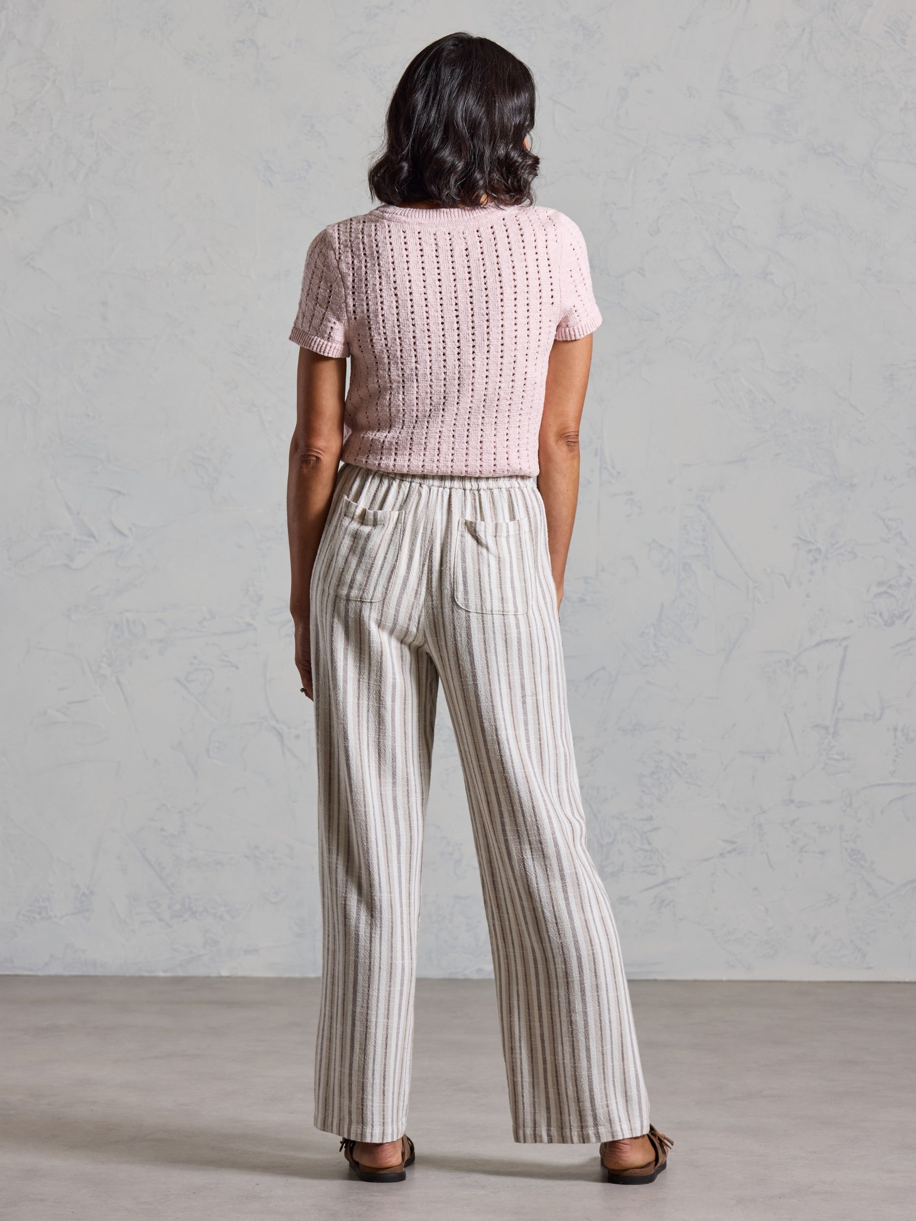 Back view of the Jolie Linen Blend Pants in driftwood, showing back patch pockets and wide leg drape.