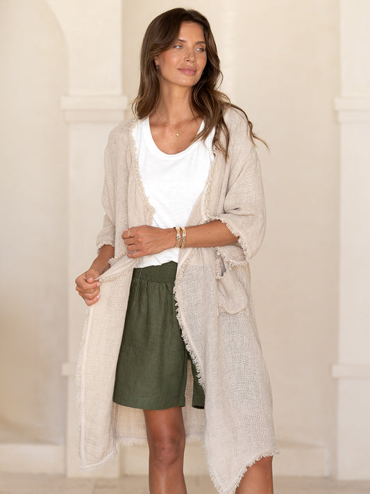 Model wearing the Laguna French Linen Kimono in natural over a white tee and olive linen short