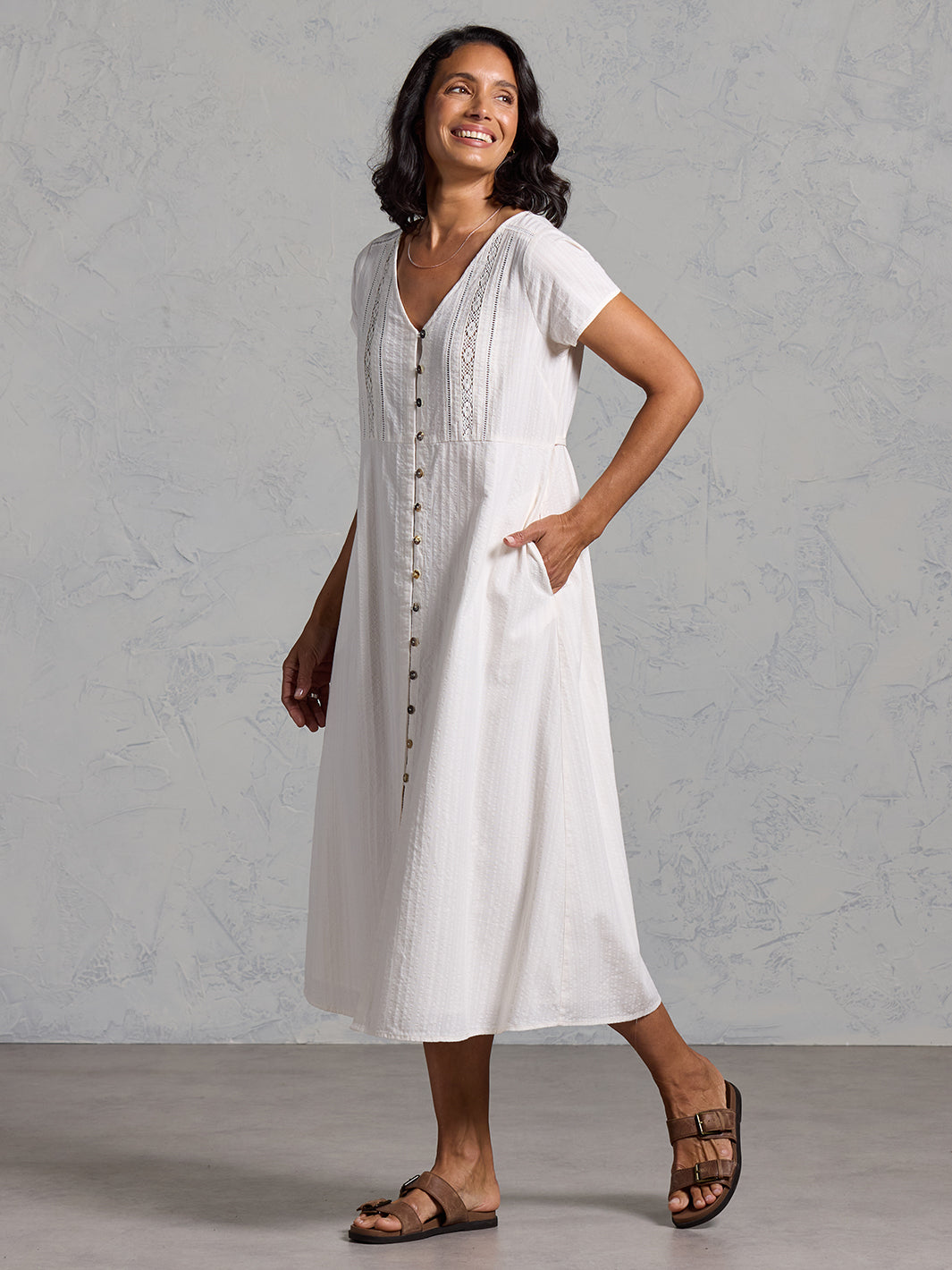 A woman wearing a cotton dress in coconut from Nomad the Label