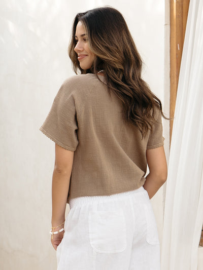 Model wears Daisy Organic Cotton Blouse in Cinnamon.