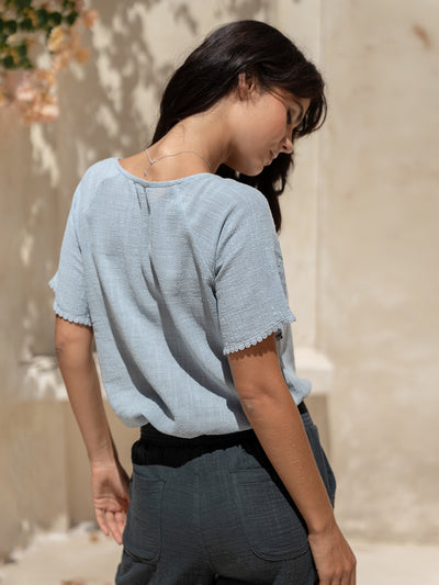 Model wears Daisy Organic Cotton Blouse Slate Blue