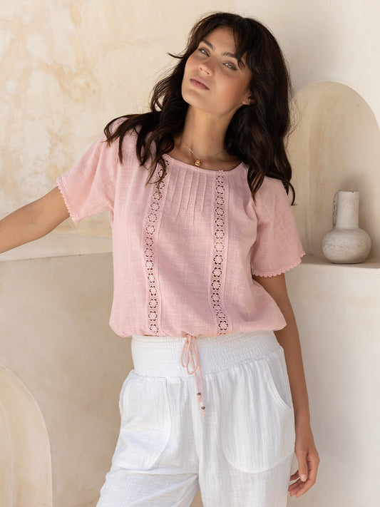 Model wears Model wears Daisy Organic Cotton Blouse in Dusty Pink.