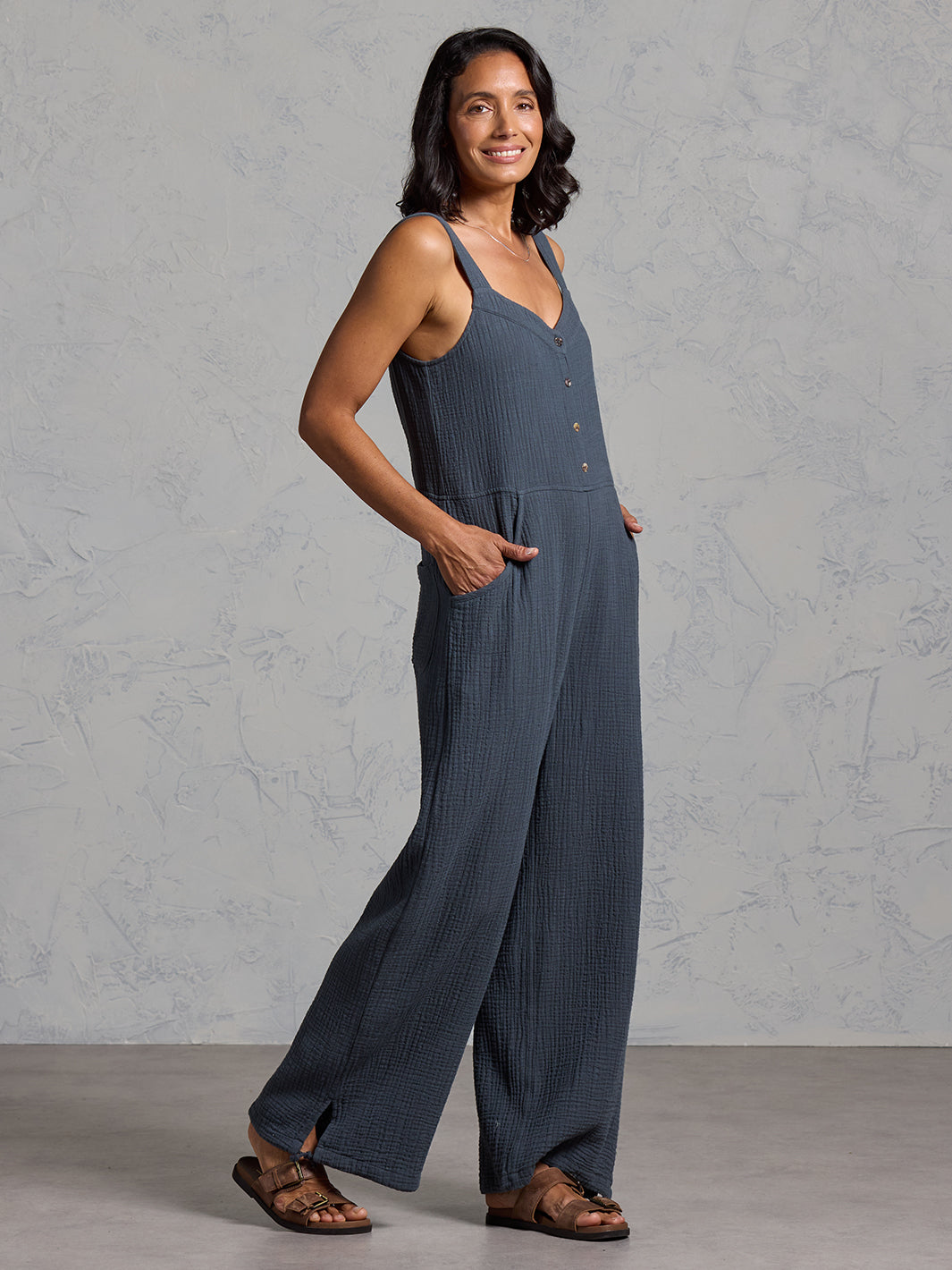 A woman wearing a charcoal cotton jumpsuit from Nomad the Label
