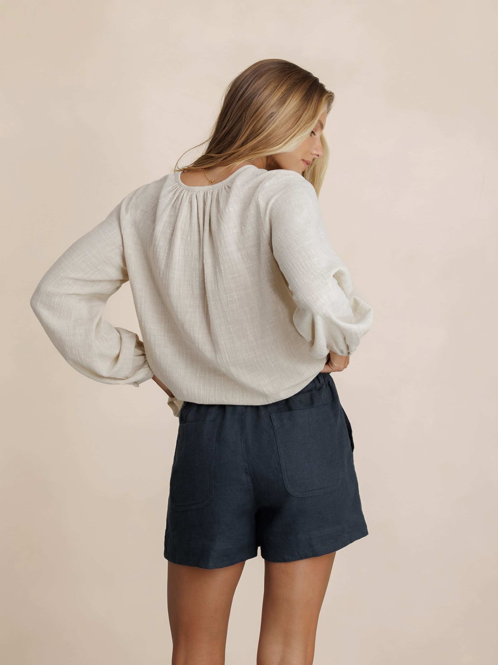 Model wears Dahlia Linen Shorts in Charcoal
