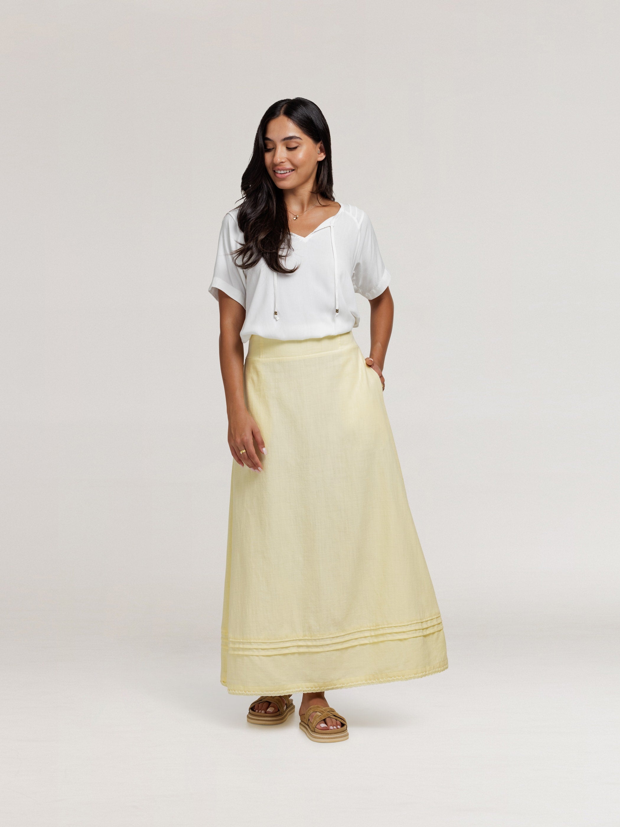 Model wears Isabella Bamboo Blouse in Ivory & Bordeaux Cotton Skirt in Lemon