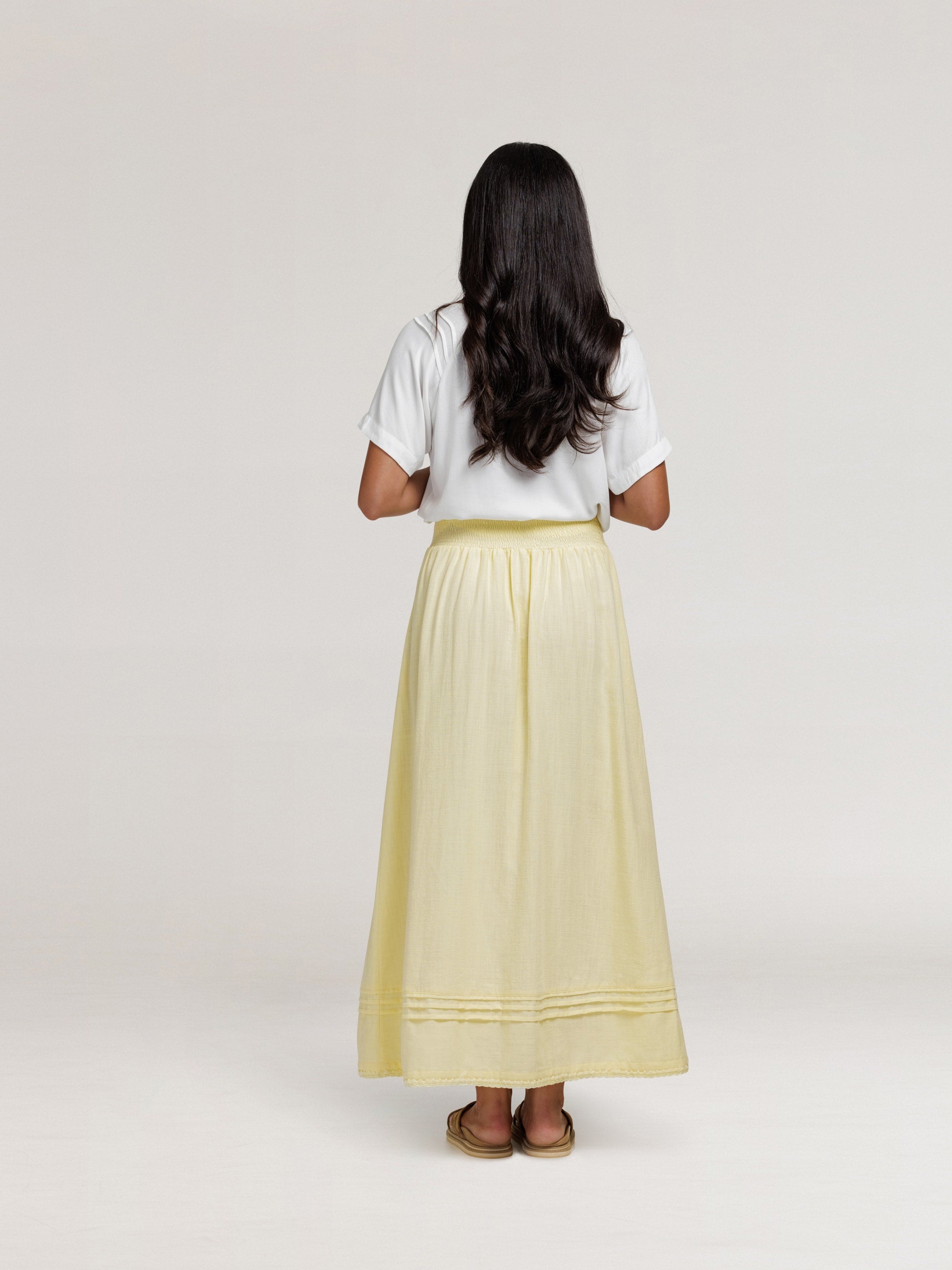 Model wears Bordeaux Cotton Skirt in Lemon