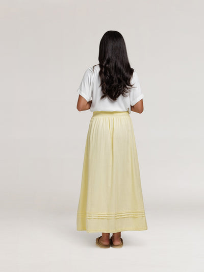 Model wears Bordeaux Cotton Skirt in Lemon