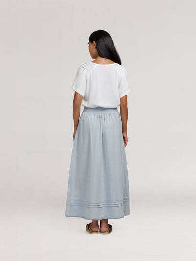Model wears Bordeaux Cotton Skirt in Slate Blue