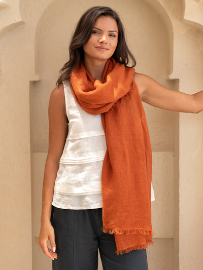 Model wears Lumi Linen Scarf in Rust