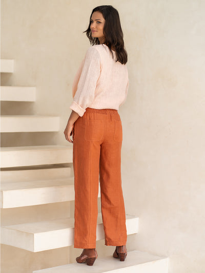 Model wears Morrissey Linen Twill Pants in Rust