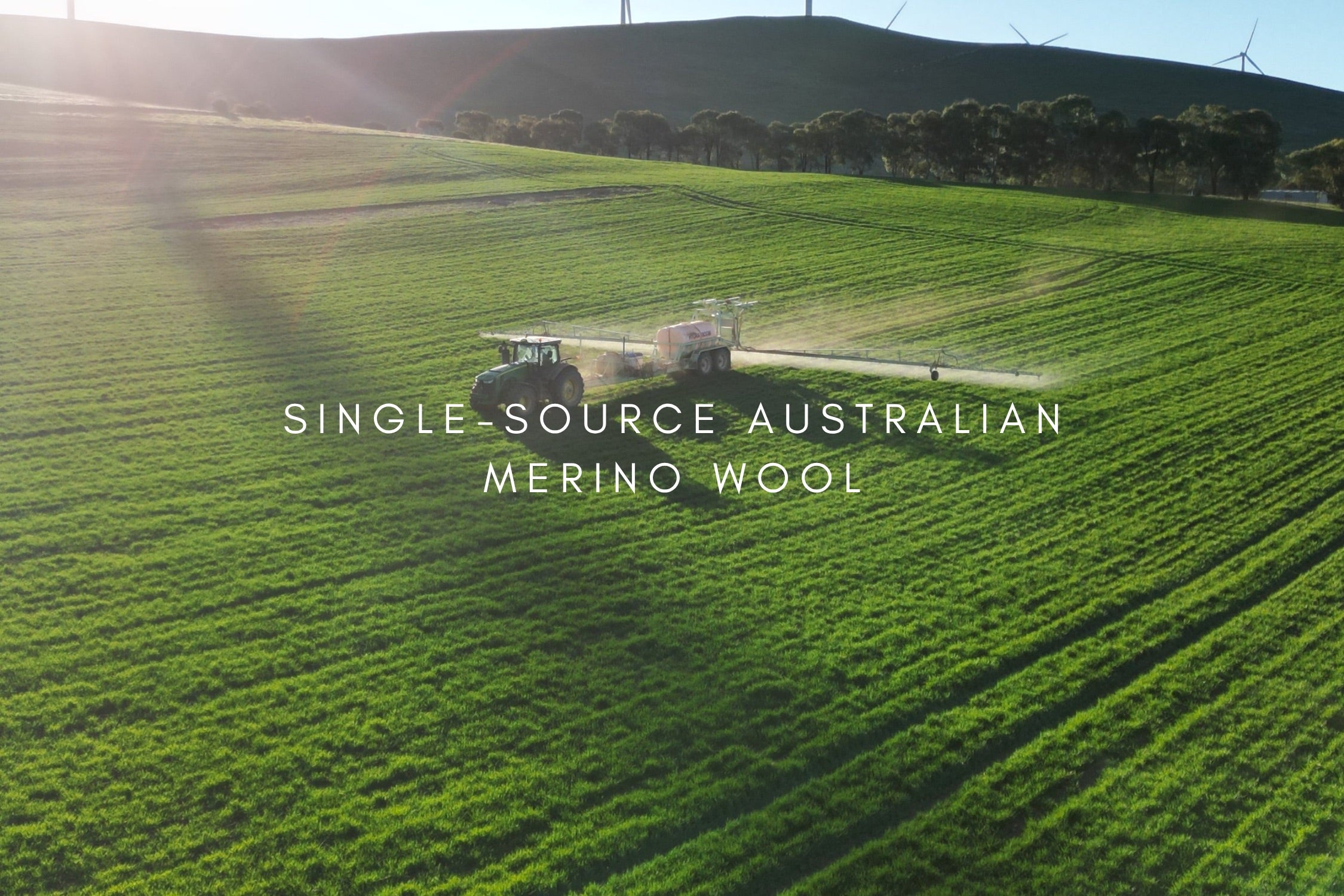 Tractor in a field with text 'Single-Source Australian Merino Wool' on a green landscape.