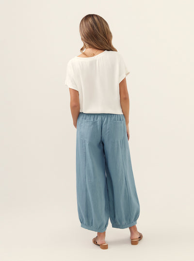 Model wears Sadhu French Linen Pants Regular in Tahiti Blue.