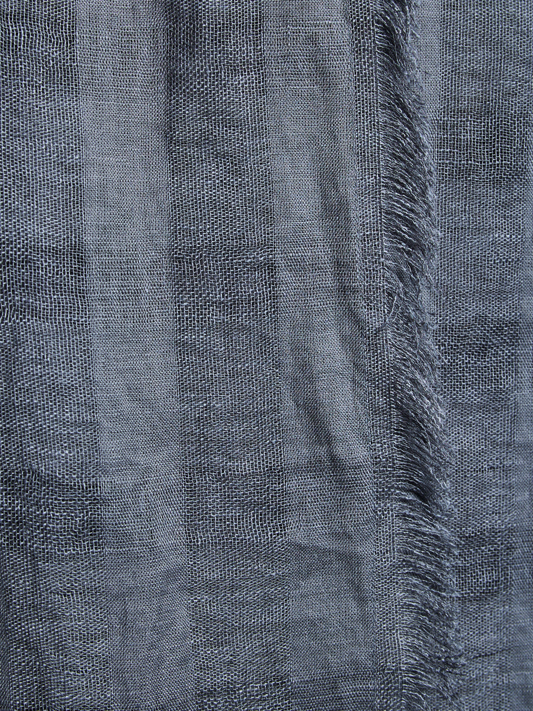 Close-up of a textured gray fabric with frayed edges