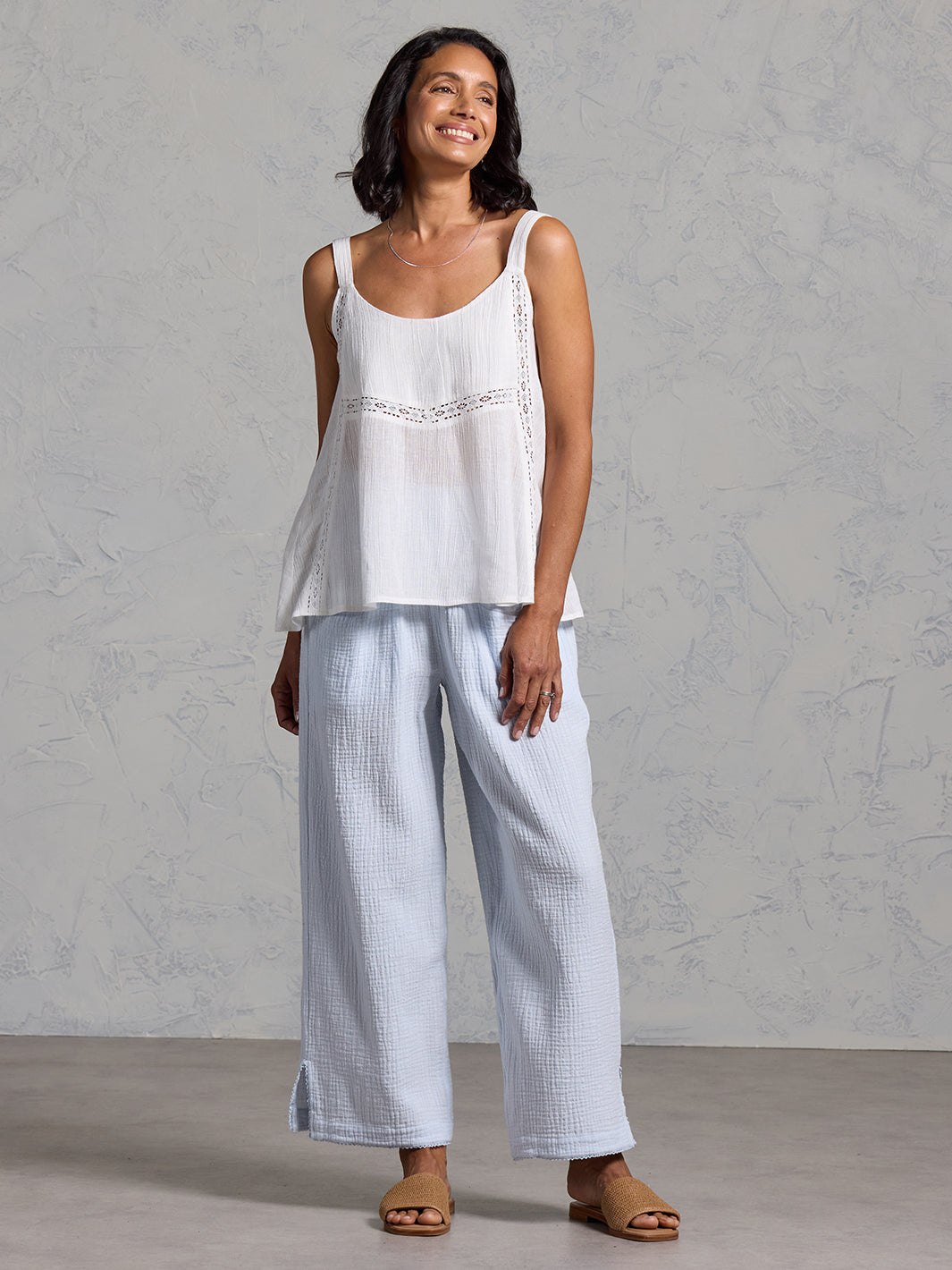 A woman wearing a coconut linen top from Nomad the Label