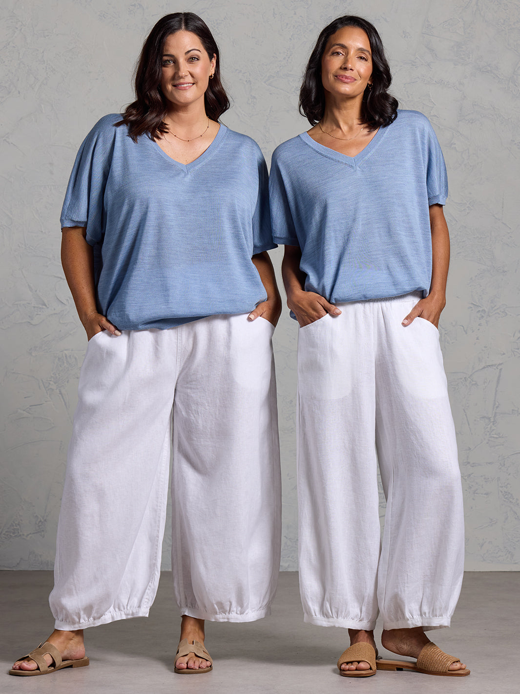 A woman wearing Toscana Merino Wool Top Sea Blue and Sadhu French Linen Pants White