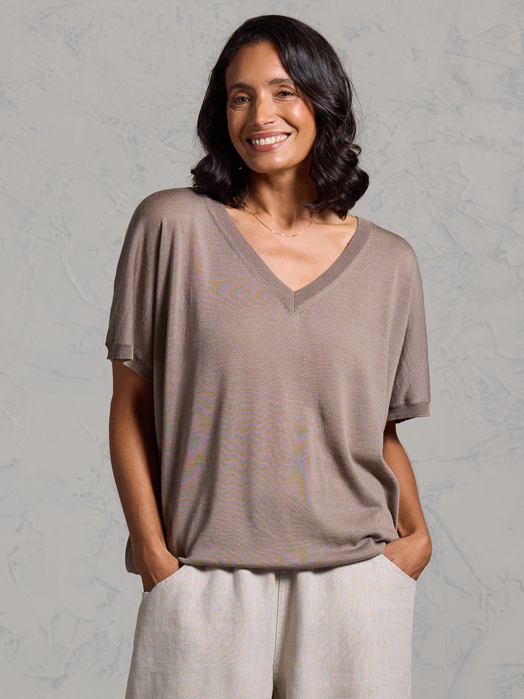 A woman wearing Toscana Merino Wool Top Elm and Sadhu French Linen Pants Flax