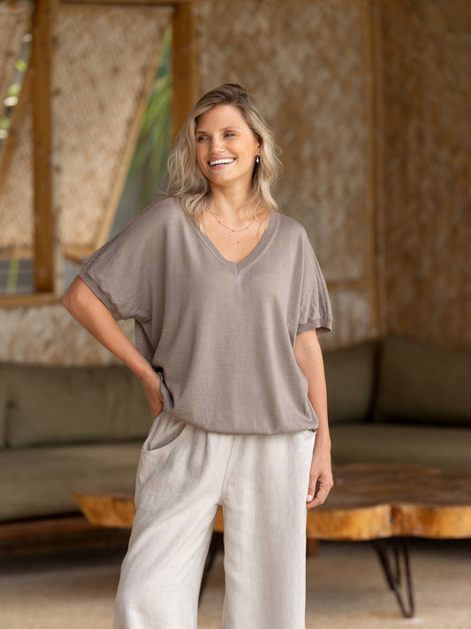 A woman wearing Toscana Merino Wool Top Elm and Sadhu French Linen Pants Flax